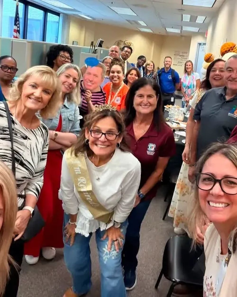 Chris Reid and his team gathered with school staff at a retirement celebration