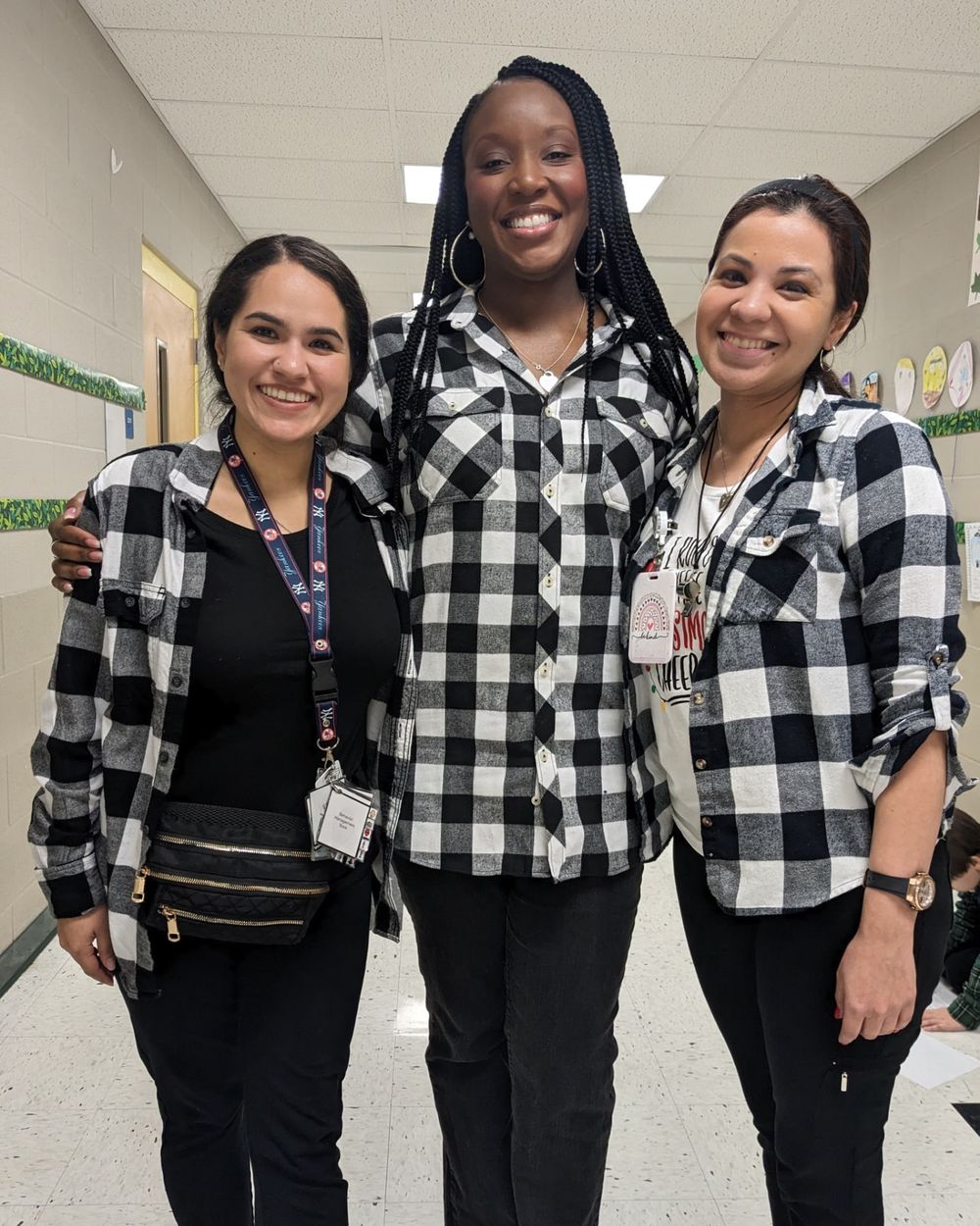 Educators Chris Reid and his team work with, together in a school hallway